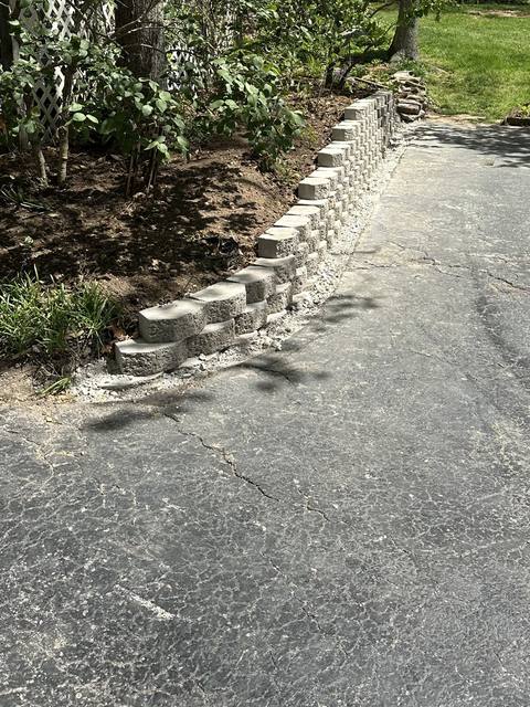 Block wall curving along the edge of a drive