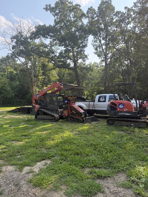Excavator, mulcher and loader at a job