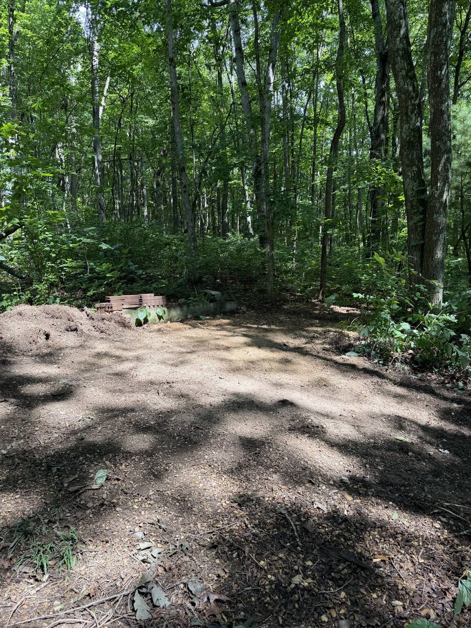 After: the shed gone, a cleared dirt pad