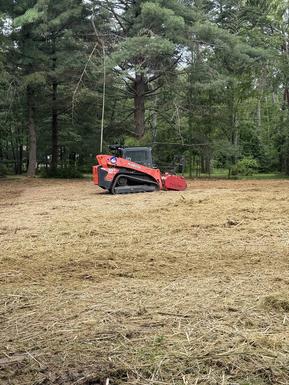 Track loader with forestry mulcher on a freshly mulched lot