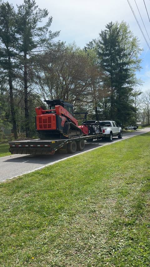 Truck and trailer hauling the track loader