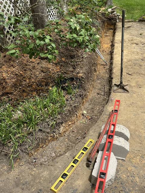 Base course trench with levels during the wall build